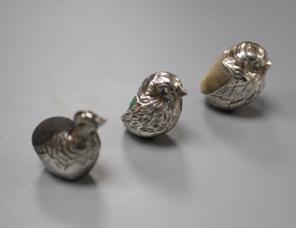 An Edwardian silver mounted hatching duckling pin cushion, Birmingham, 1908, 23mm and two modern silver pin cushions.